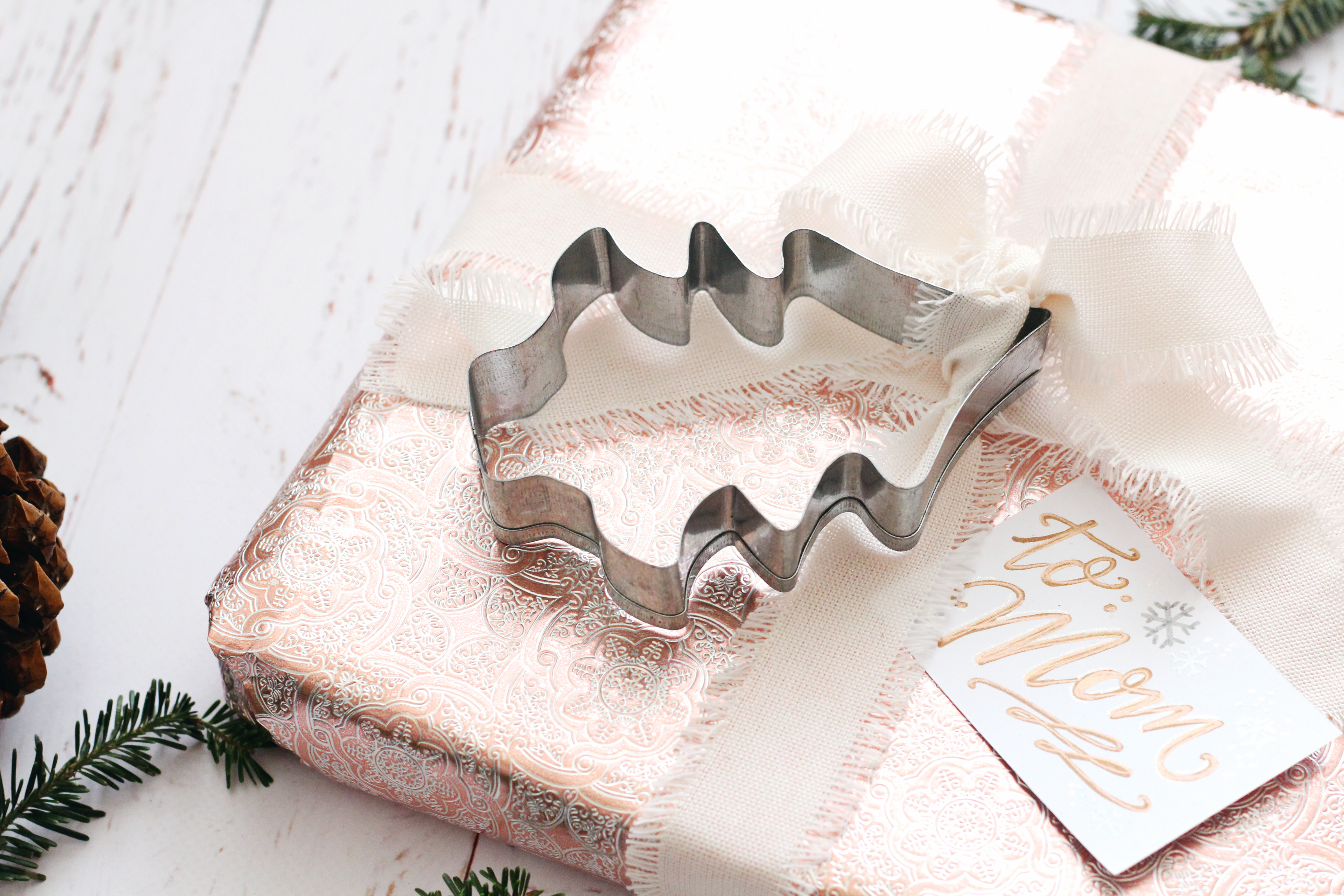 Use a Christmas cookie cutter as a cute gift wrap embellishment