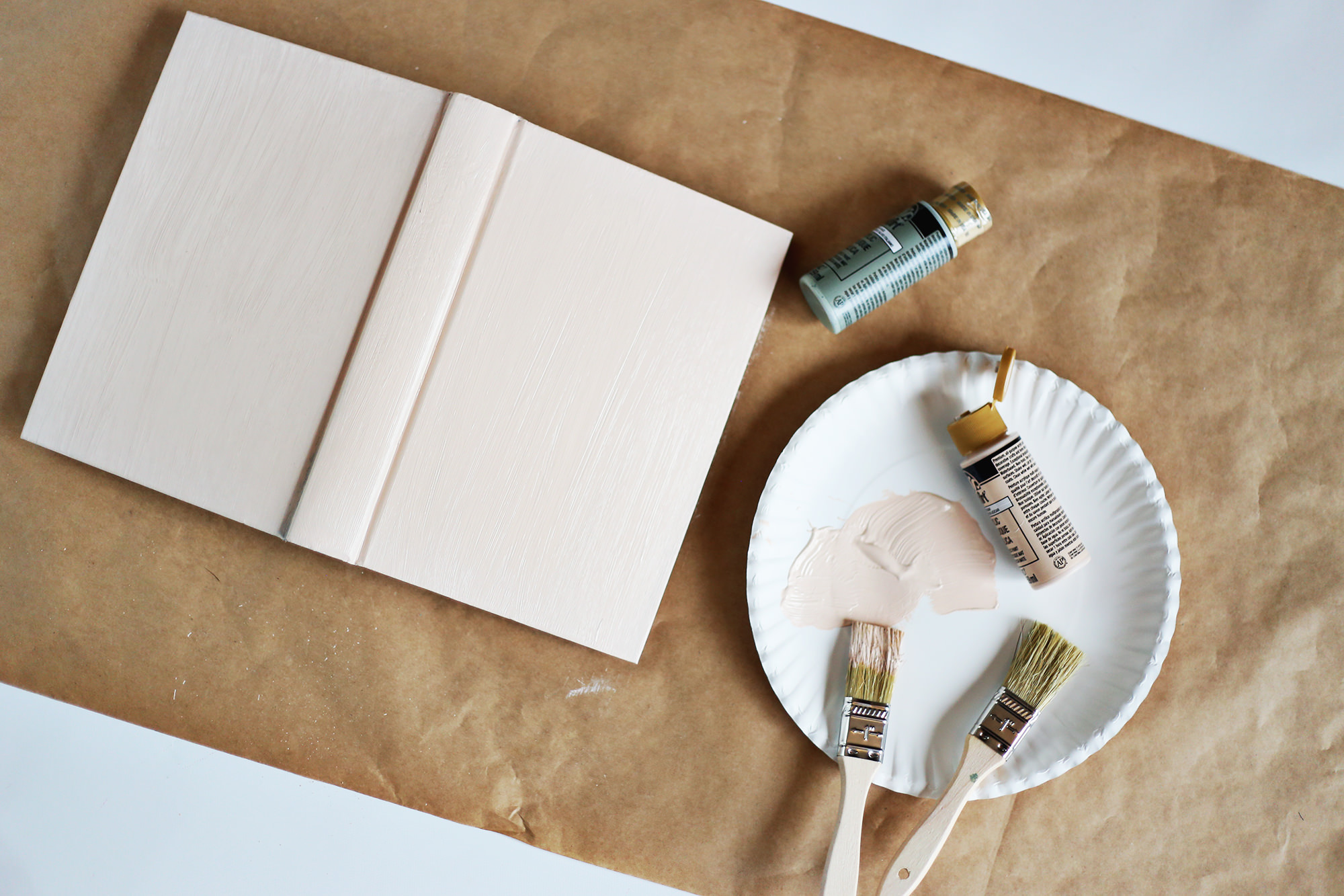 Painting old books in neutral colors makes them easy to use when styling a nightstand or a bookshelf!