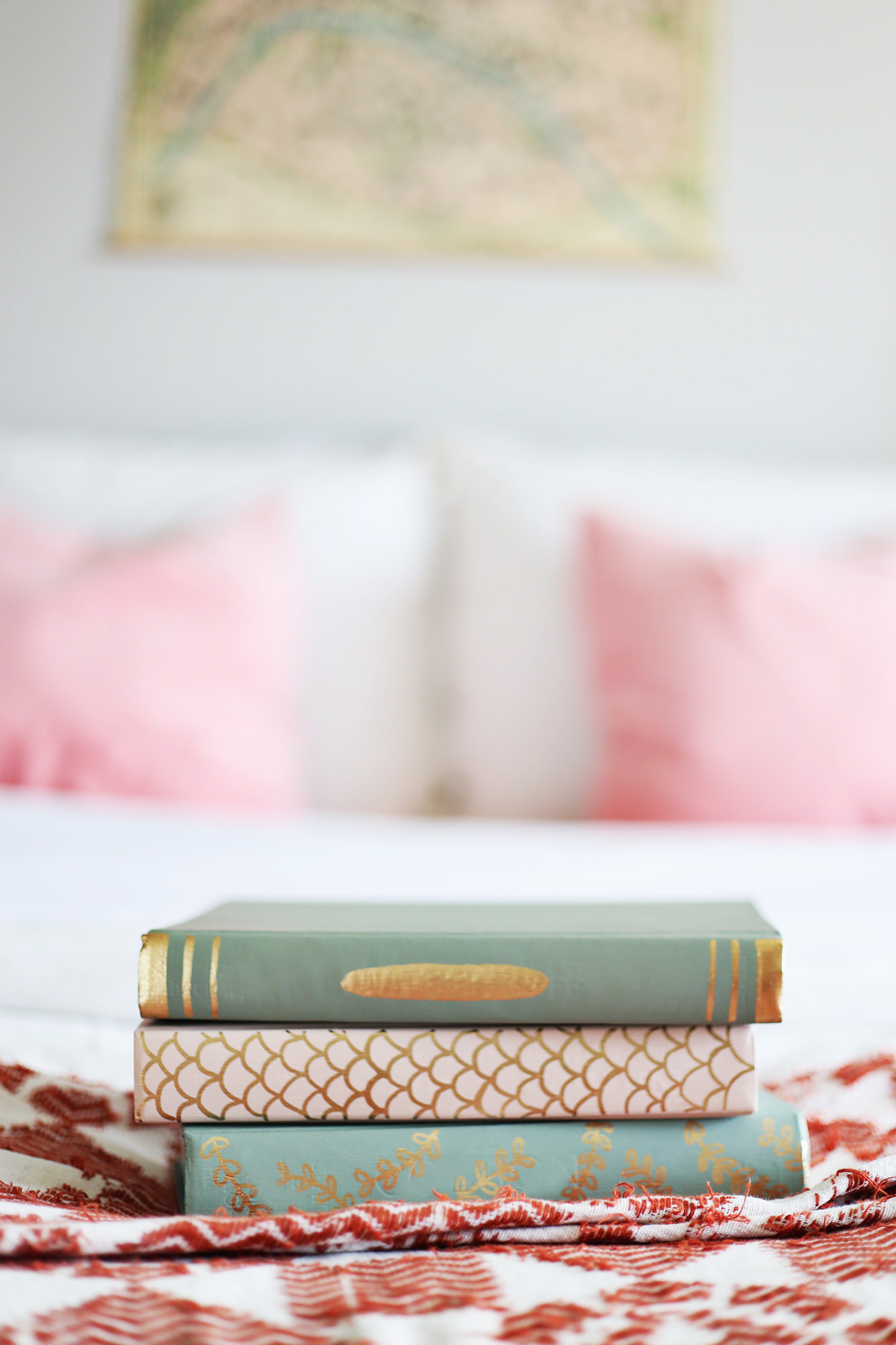 Grab a stack of old books and repaint them to fit your style! See the full DIY on lilyandval.com!