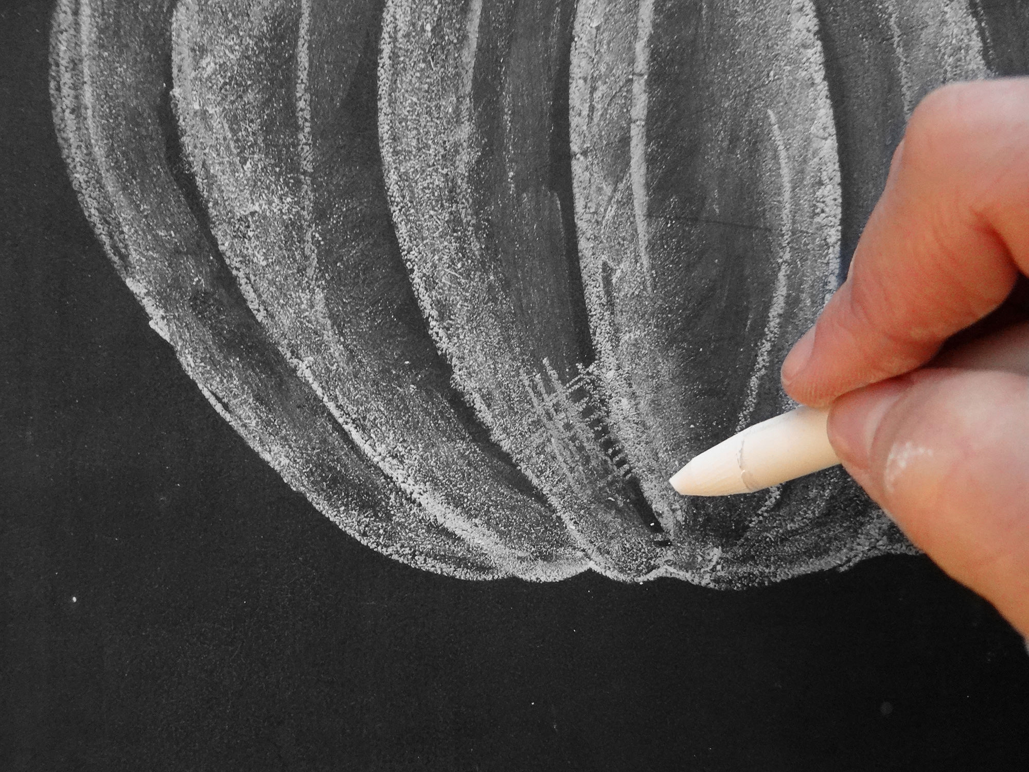 Valerie McKeehan, author of The Complete Book of Chalk Lettering, gives a step-by-step tutorial on how to draw a chalk pumpkin.