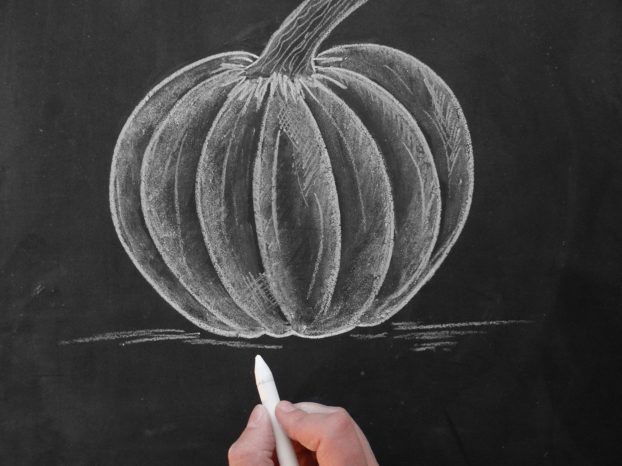 Valerie McKeehan, author of The Complete Book of Chalk Lettering, gives a step-by-step tutorial on how to draw a chalk pumpkin.