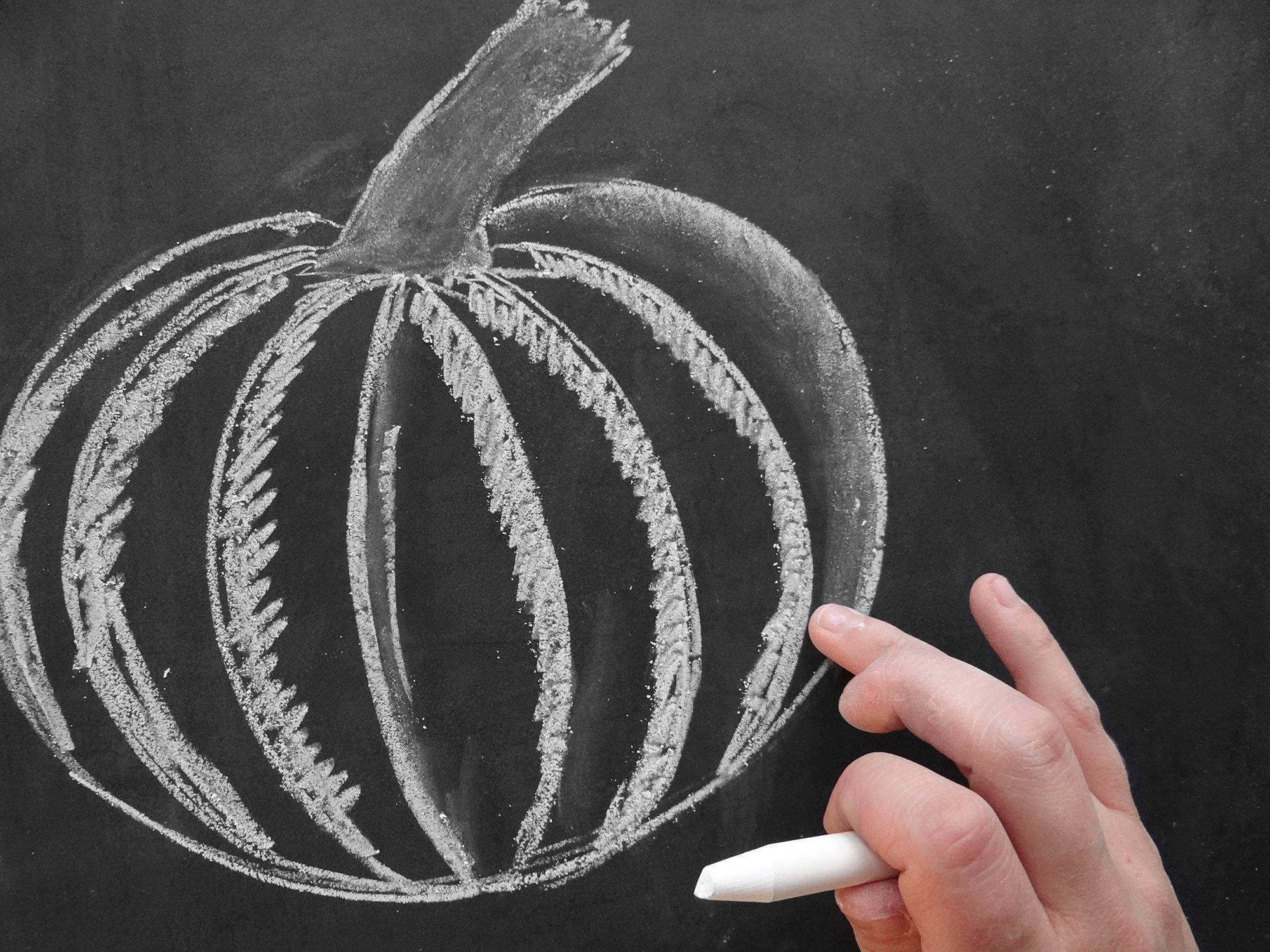 Valerie McKeehan breaks down the steps for how to draw a chalk art pumpkin on the Lily & Val Blog