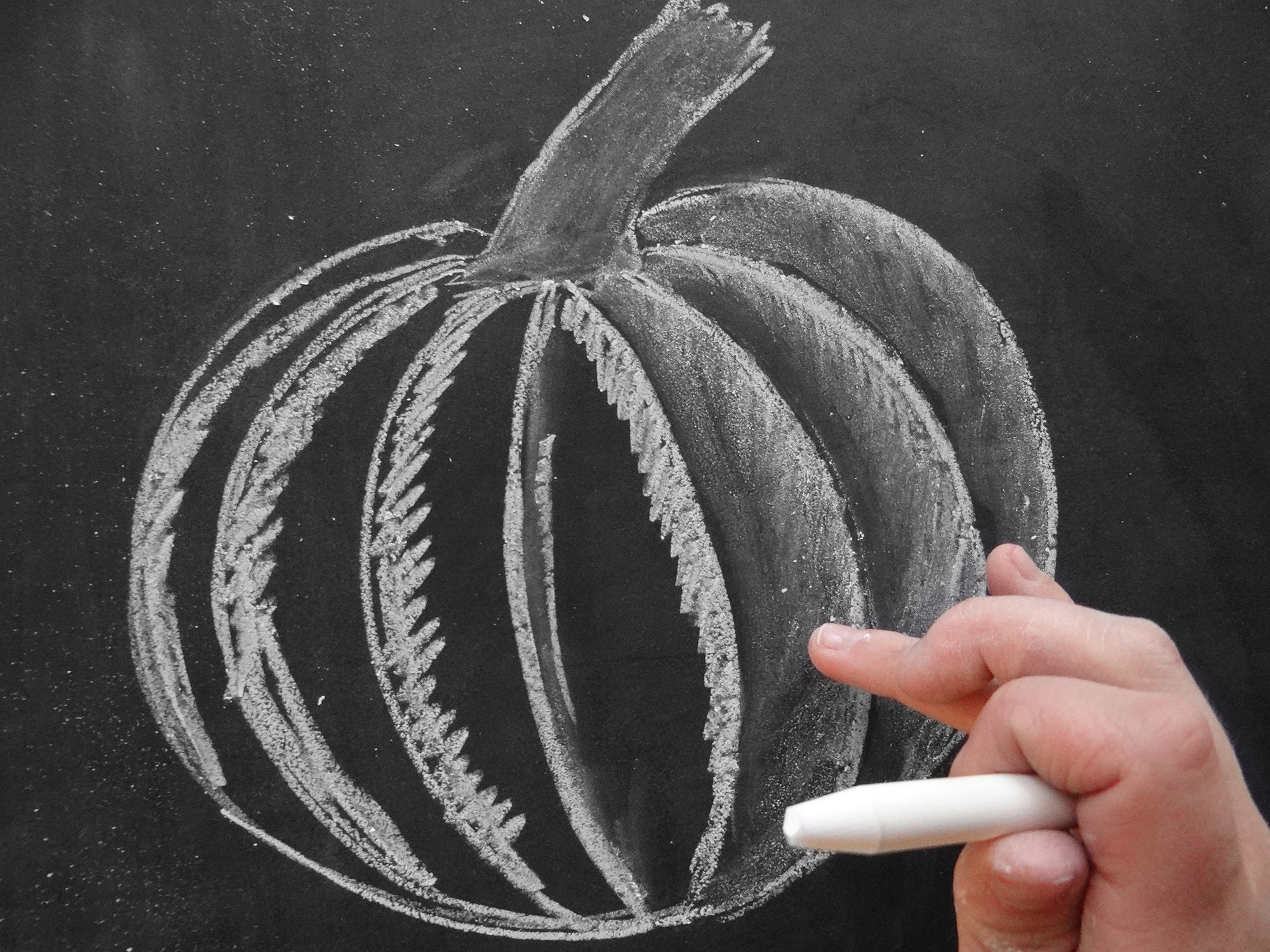 Valerie McKeehan, author of The Complete Book of Chalk Lettering, gives a step-by-step tutorial on how to draw a chalk pumpkin.