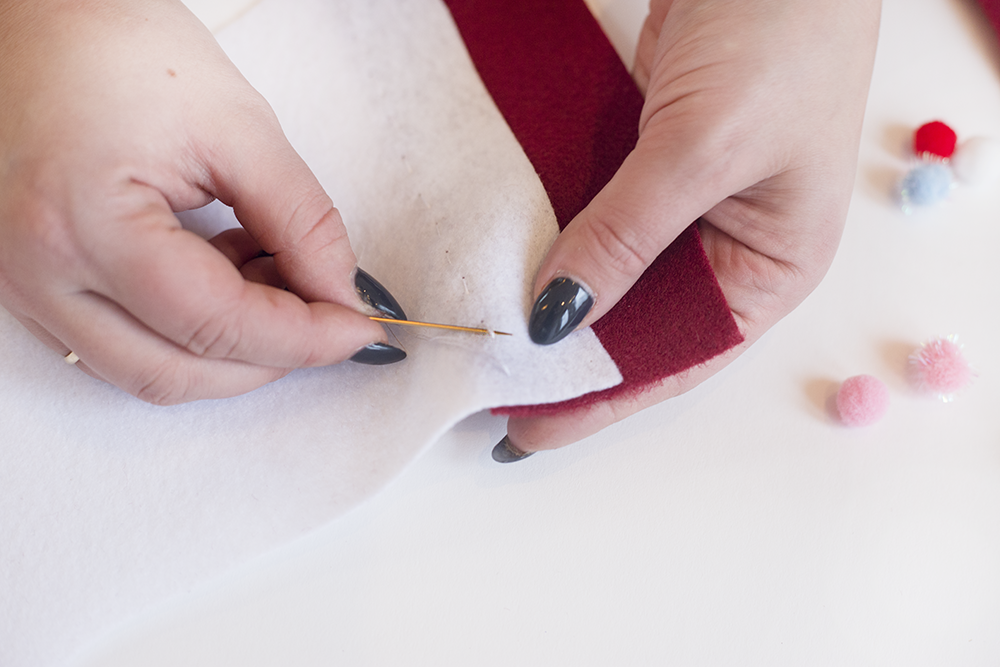 Need an easy holiday DIY? Try our hand-stitched felt stocking! It's cute, inexpensive, and only takes about an hour. Click through to read the steps and add some festive adorableness to your mantle!