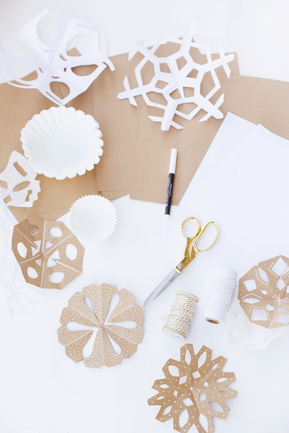 How to Make Paper Snowflakes Into Ornaments Using Paper Doilies