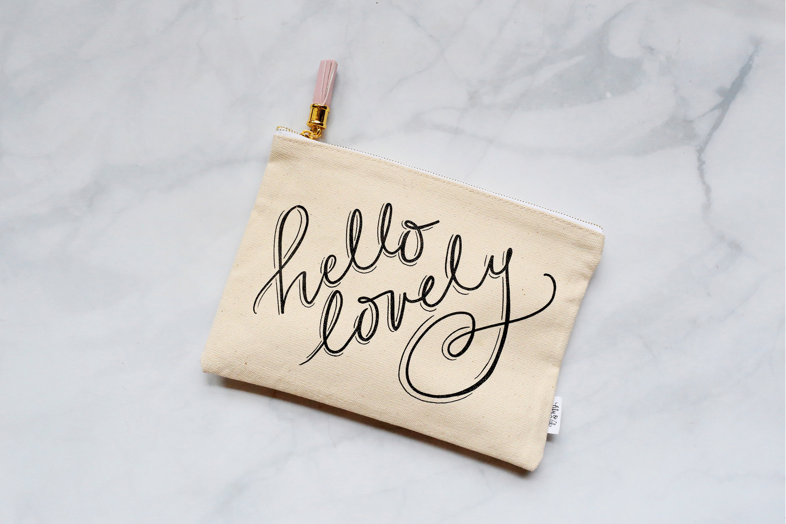 Fill our new zippered pouch with your favorite beauty bits! Lily & Val