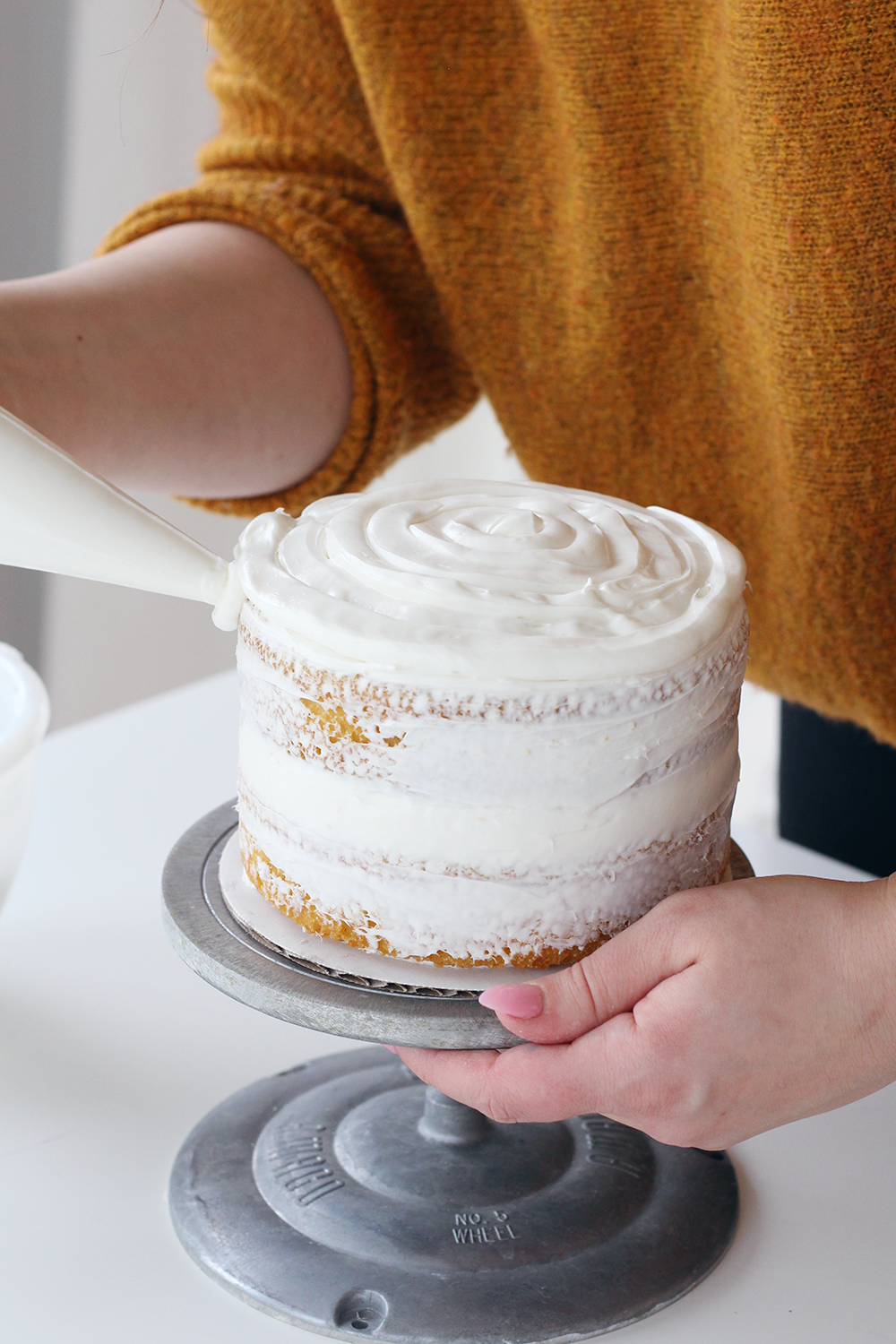 How to ice a two-tiered cake like a pro on the Lily & Val Blog