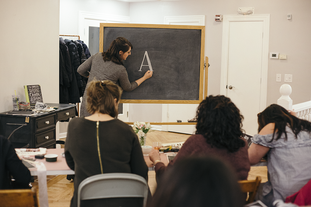 Valerie McKeehan, author of The Complete Book of Chalk Lettering, teaching a Chalk Lettering Techniques Workshop at the Lily & Val Flagship Store in Pittsburgh