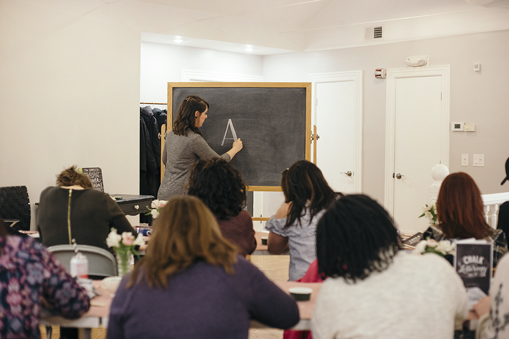 Valerie McKeehan, author of The Complete Book of Chalk Lettering, teaching a Chalk Lettering Techniques Workshop at the Lily & Val Flagship Store in Pittsburgh