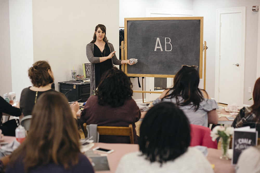 Valerie McKeehan, author of The Complete Book of Chalk Lettering, teaching a Chalk Lettering Techniques Workshop at the Lily & Val Flagship Store in Pittsburgh