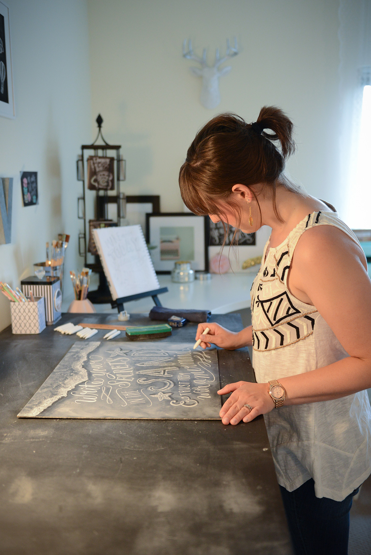 Valerie McKeehan, author of The Complete Book of Chalk Lettering, drawing in her studio