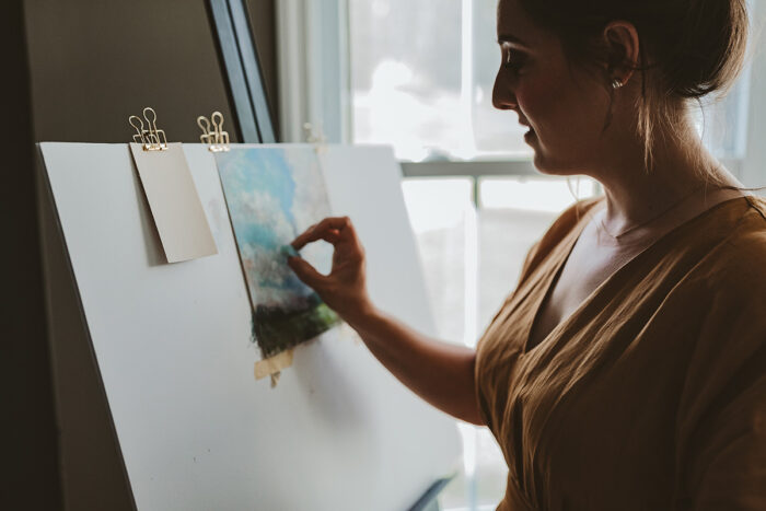 Valerie McKeehan in her studio painting with soft pastels